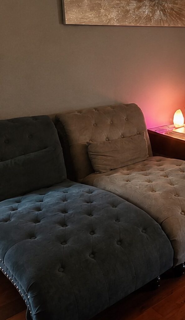Tufted lounge chairs beside a glowing salt lamp in the Blue Mountain Mist Spa relaxation room